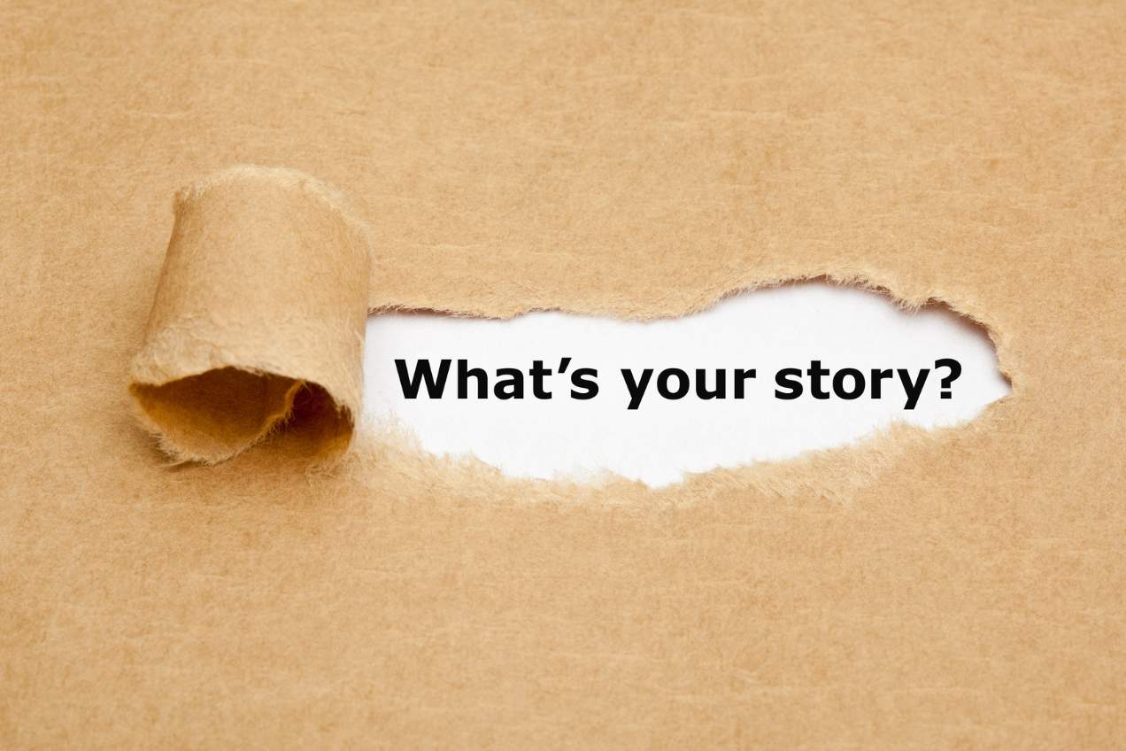 Torn brown paper revealing the words: What's your story?